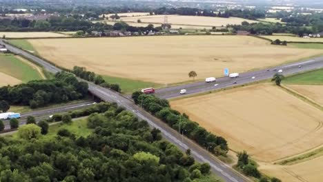 aerial view across agricultural meadows and fields in rural uk countryside following m62 motorway