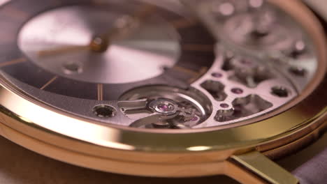 close up on luxurious rotating mechanical piaget wristwatch clockwork timepiece craftsmanship details