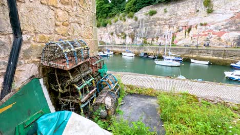 fishing gear and boats in scenic scottish harbor