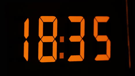 orange display digital clock with hours flying by