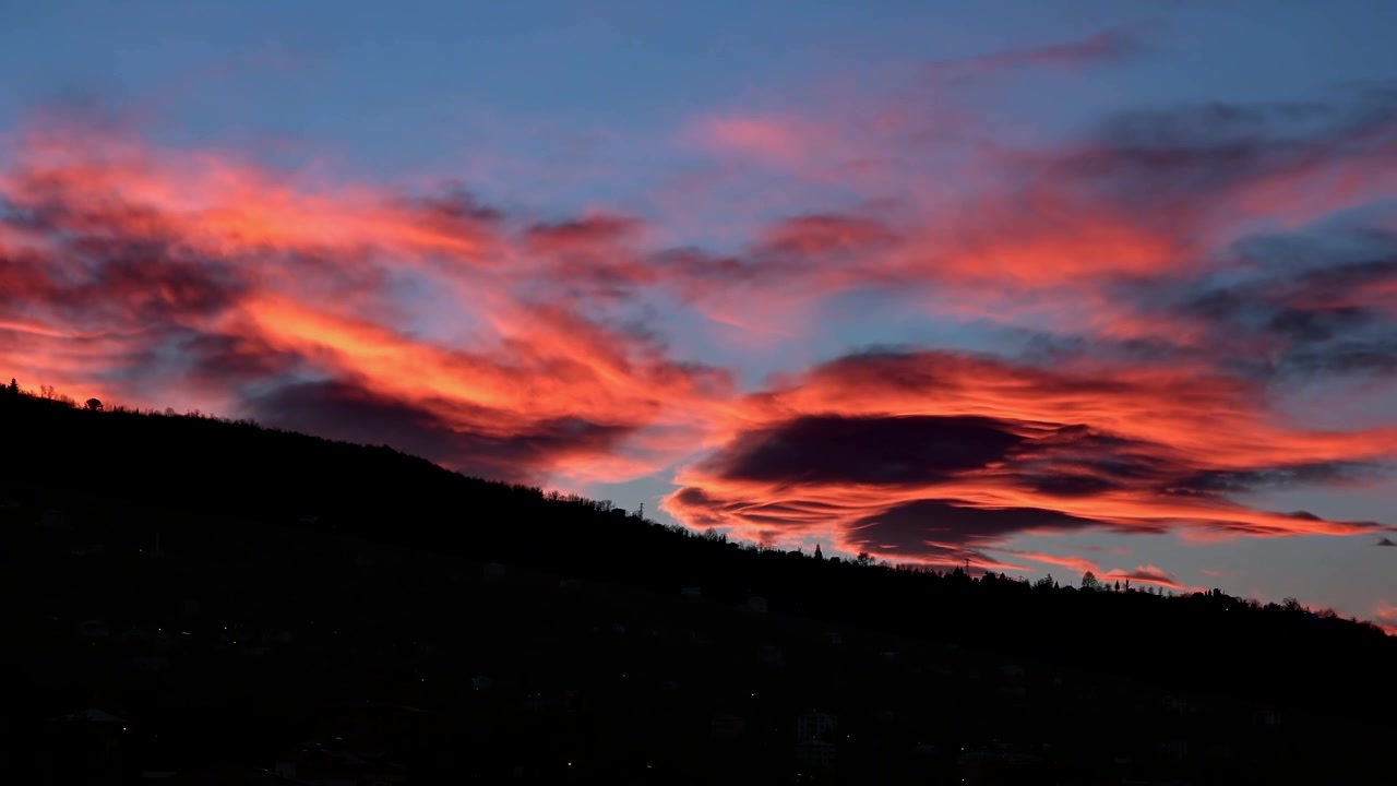 Time Lapse of Dramatic Sunset Clouds Over a Hillside