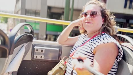 carefree woman with hair blowing on a sightseeing bus, athens, greece