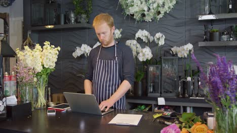 man at counter in shop