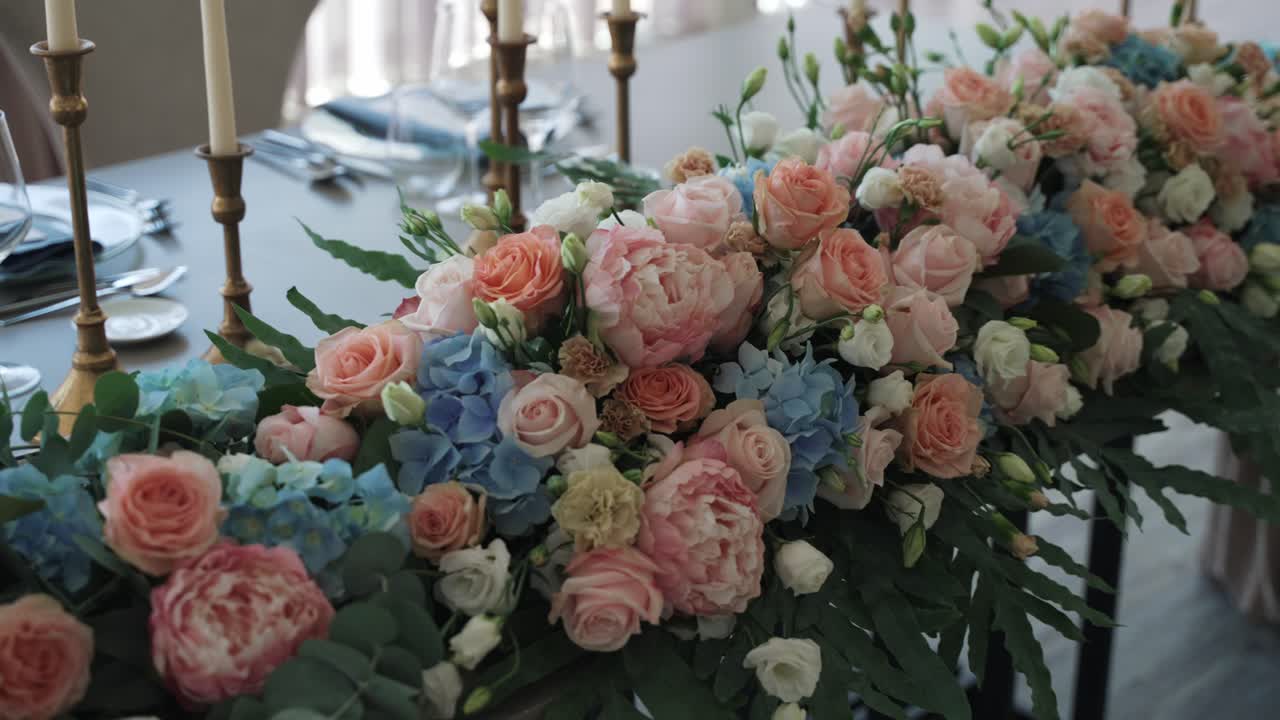elegant table arrangement with pastel roses hydrangeas and peonies for a wedding reception