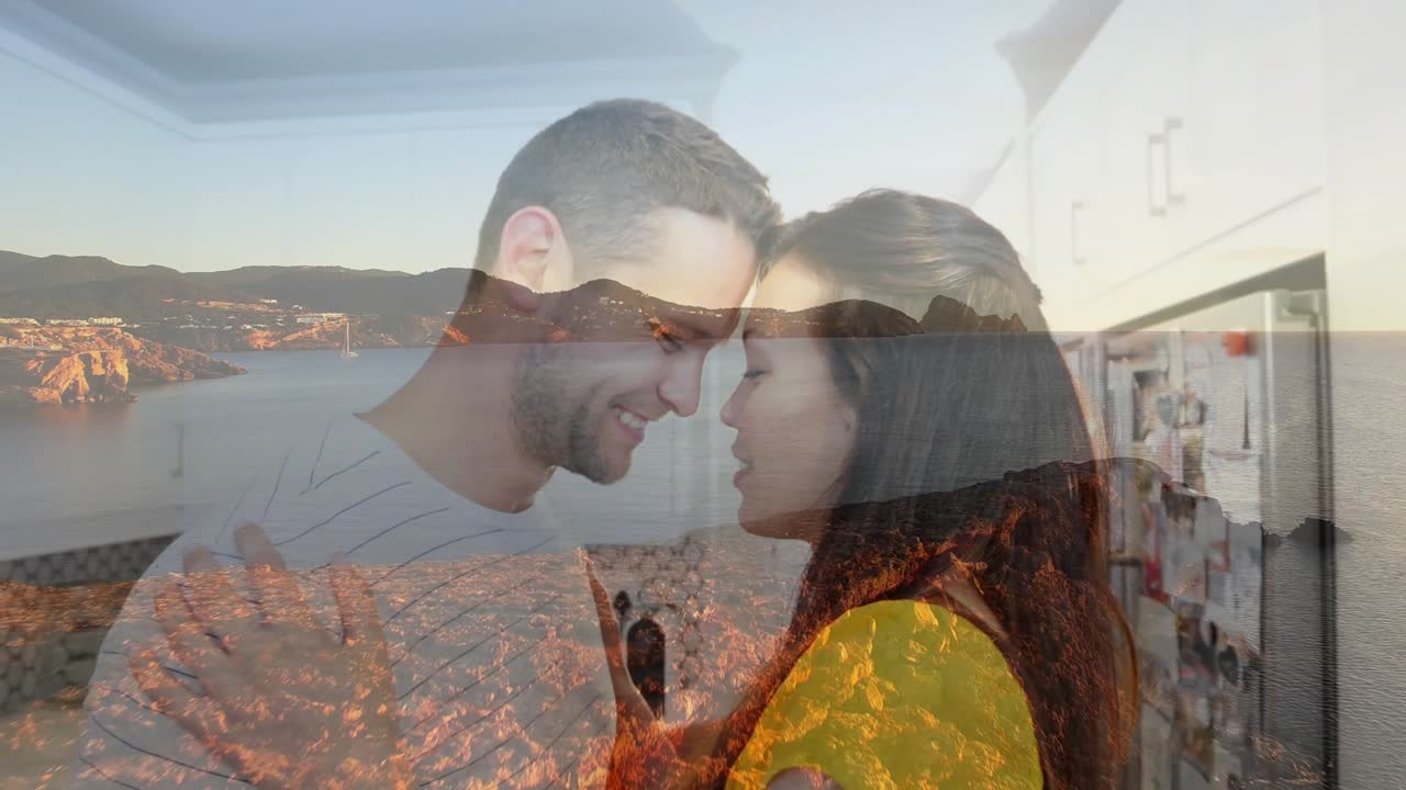 Casal em um momento divertido de culinária caseira, após um gesto de agitar, progredindo para um abraço terno.