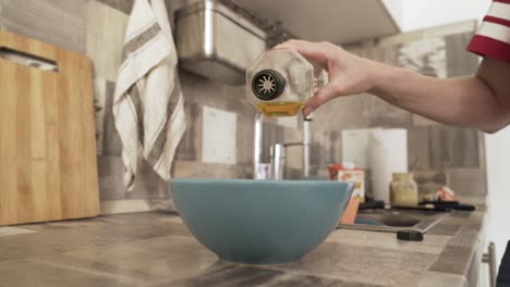 pouring oil into a bowl