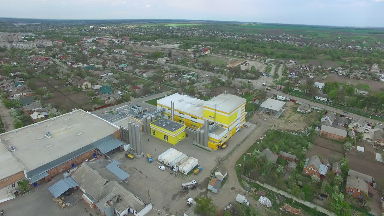 Aerial view of warehouse with trucks. Industrial background. Logistics from above