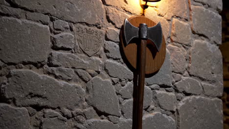 medieval axe mounted on stone wall