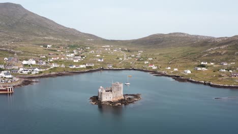 Point-of-interest-drone-shot-of-Kisimul-castle-and-the-town-of-Castlebay-on-the-Isle-of-Barra-in-the-Outer-Hebrides-of-Scotland