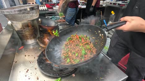 street food vendor cooking stir-fried meat and vegetables