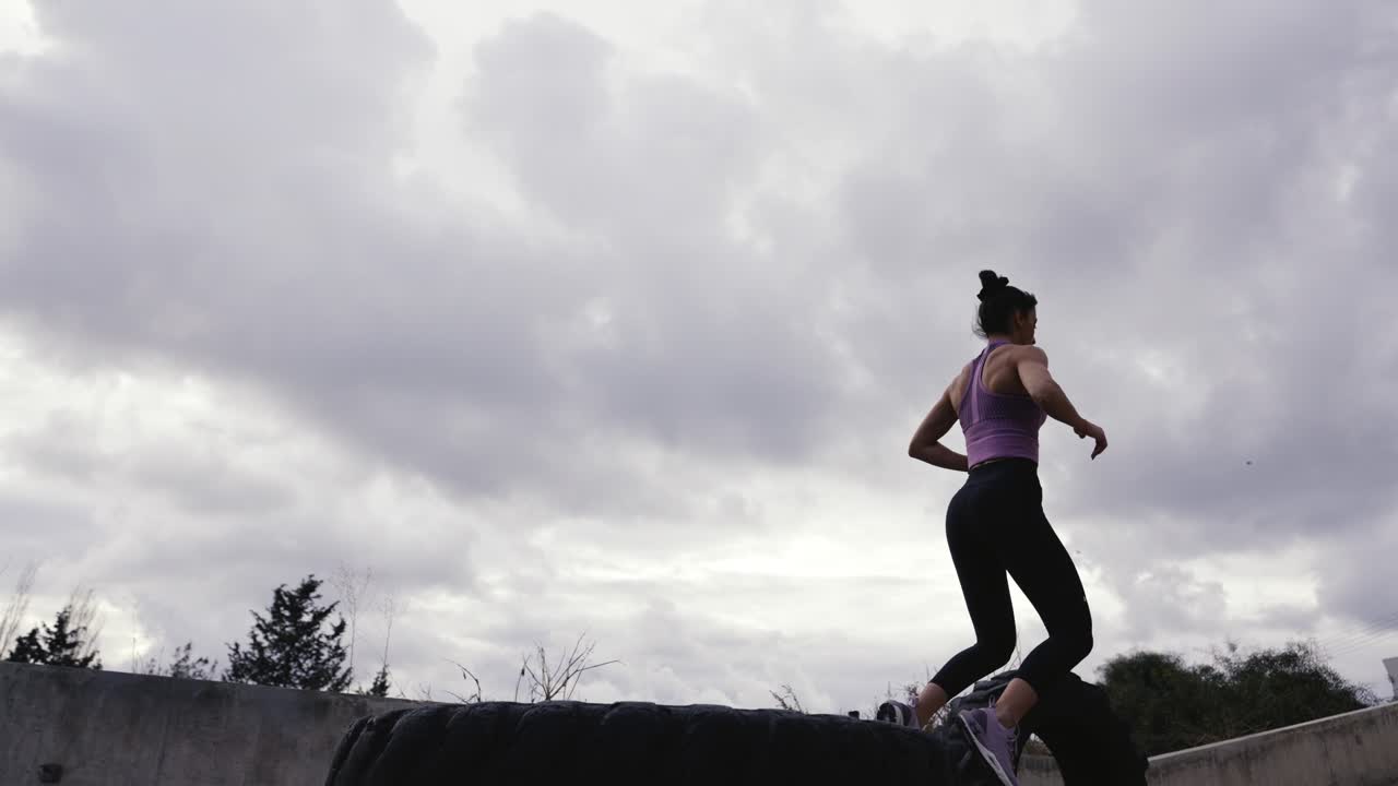 Full length profile side photo of joyful girl athlete doing sport exercise sit squats stretch hands want be strong wellbeing woman wearing grey pants in house like gym