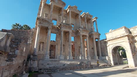 panning view capturing both the library of celsus and the gate of mazeus and mithridates in ephesus