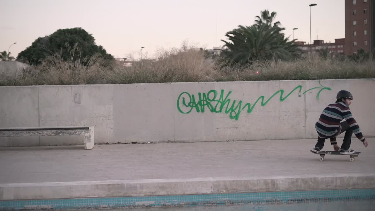 Skateboarder performing tricks in an urban skatepark