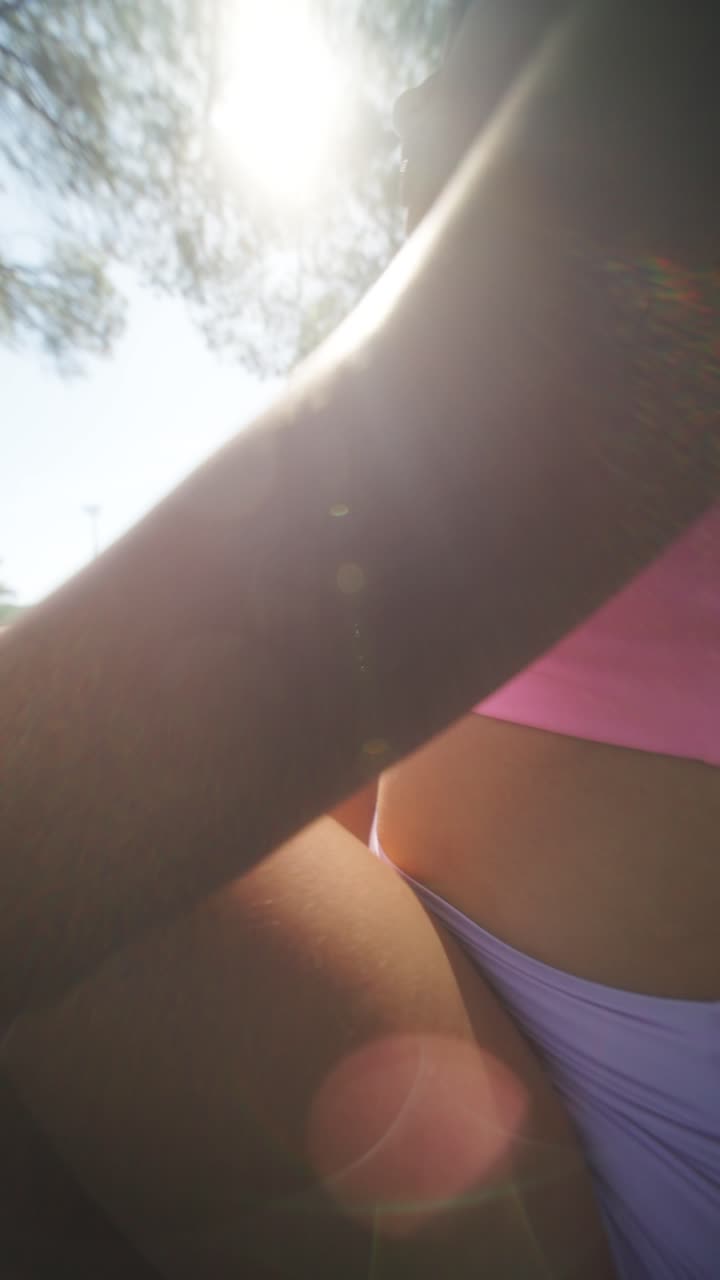 Young woman exercising outdoors in summer