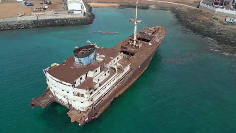 spectacular aerial view flight abandoned destroyed ghost ship shipwreck on beach sandbank lanzarote canary islands, sunny day spain 2023