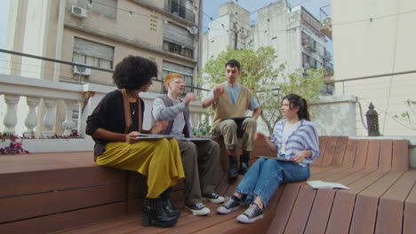 cheerful gen z business team hand stacking at outdoor coworking space