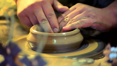 potter make clay dishes. master hands working on potters wheel