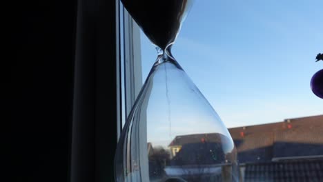 hour glass in front of the window