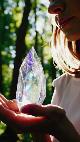 woman holding crystals in forest