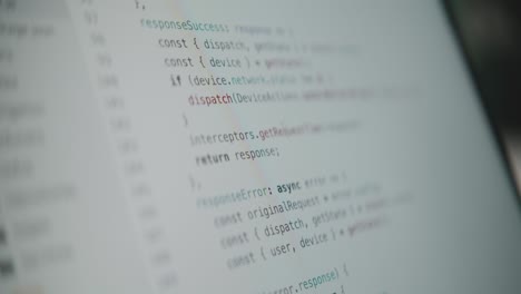 a close-up shot of a computer screen with lines of source code scrolling by quickly. a concept for programming, hacking, data streams, cyberspace, and modern technology