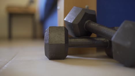 person gets out of bed but doesn't want to pick up workout weights