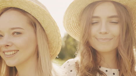 two friends wearing straw hats