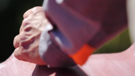 drilling a screw into a red surface with a drill