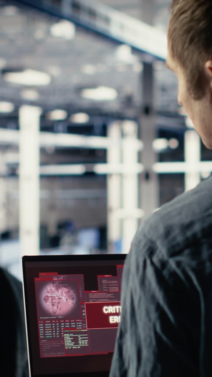 Vertical Video Engineer In Server Room Receives Critical Error Popup On Laptop Screen
