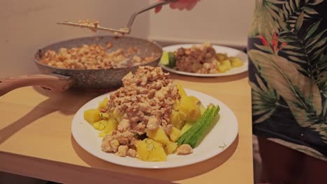 homemade chanterelle sauce and meat poured over potatoes on plate, cozy kitchen