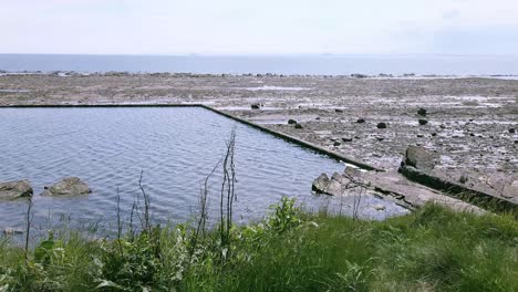 Old-sea-filled-swimming-pool-at-low-tide-in-St-Monans-Fife-Scotland