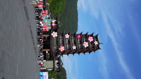 chinese mass tourism in the entrance of zhangjiajie national forest park. vertical