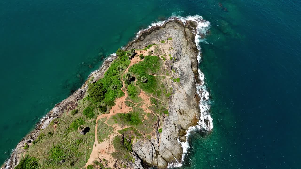Aerial view of a tropical island with rocky coast and turquoise water