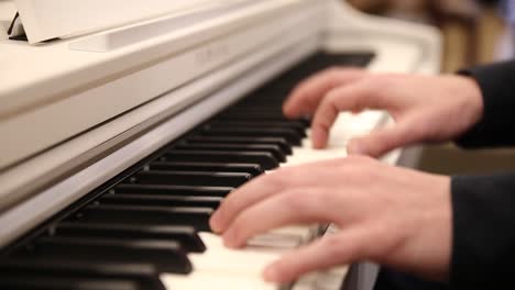Man-playing-classical-white-piano,-close-up-video
