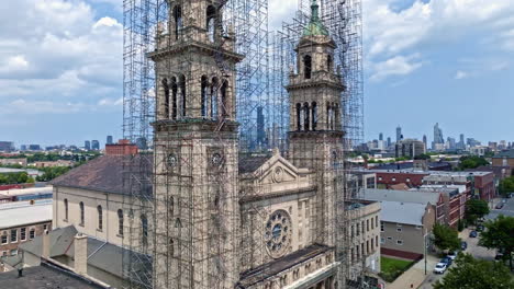 aerial view ascending in front of the st adalbert church, revealing the skyline of chicago