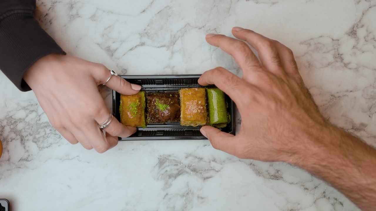 Group of friends enjoying a tray of Turkish pasties together, perfect for food, social, and cultural dining visuals