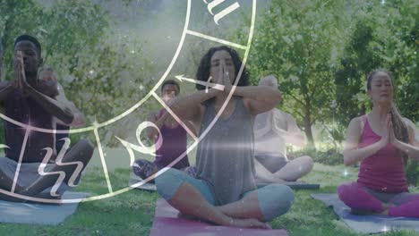 circle of zodiac signs over diverse group of people practicing yoga