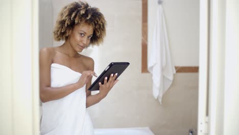 girl in bath towels using touchpad