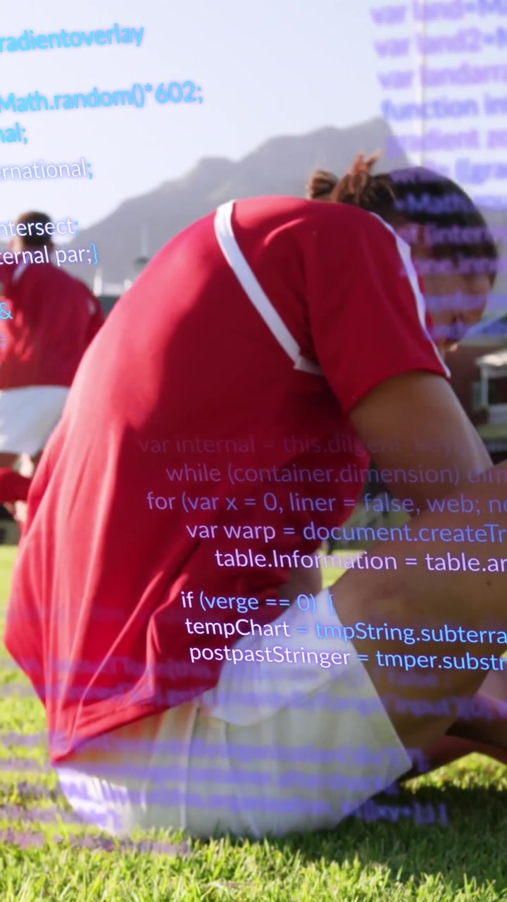 Animation of computer language over caucasian soccer player lying on ground in pain