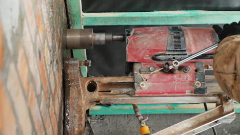 worker drills a wall with a powerful power tool makes holes for laying communications