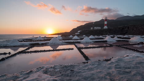 salt flats at sunset, showcasing the salinas de fuencaliente with conical salt piles, timelapse