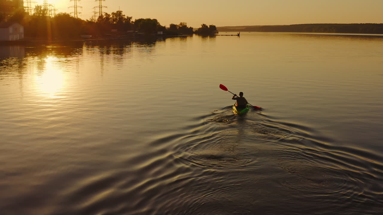 Man floating in boat on vacation. Swimming on kayak boat. Fitness workout with oars. Water tourism. Exploring river in boat. Video.