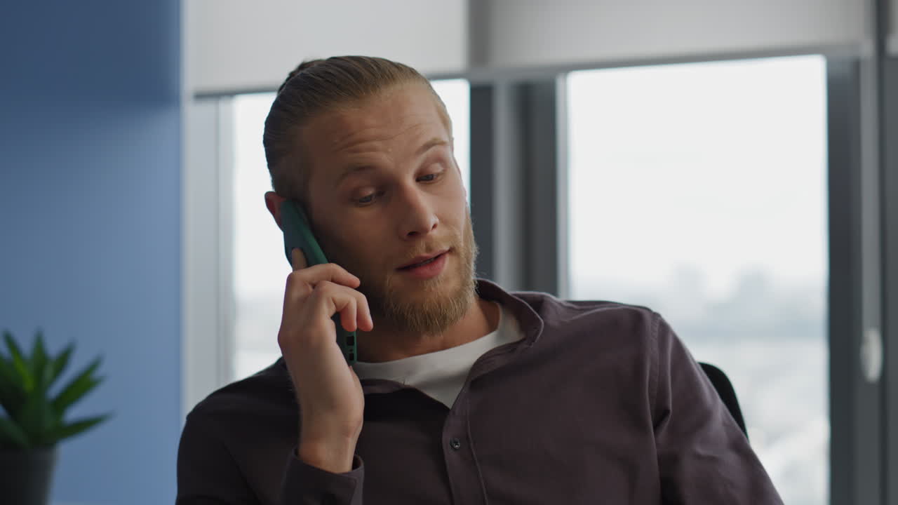 Confident freelancer calling mobile at home office close up. Man working alone
