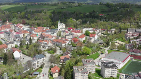 city center of old european town with tenement houses and catholic church in the middle