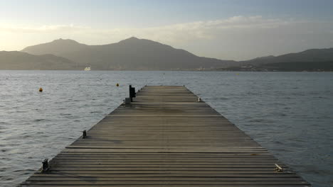 ambient seascape loop, symmetrical wooden pier, peaceful ocean