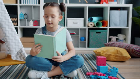 girl reading in a playroom