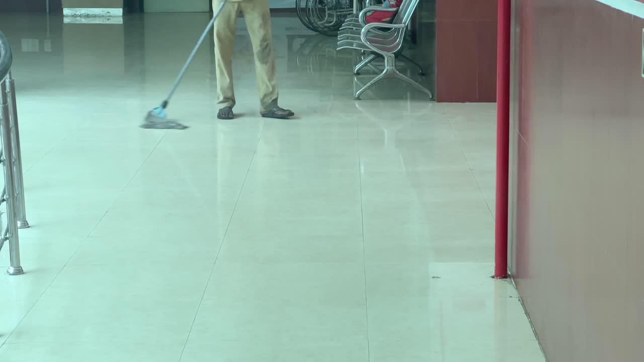 Man Mopping Floor in Hospital