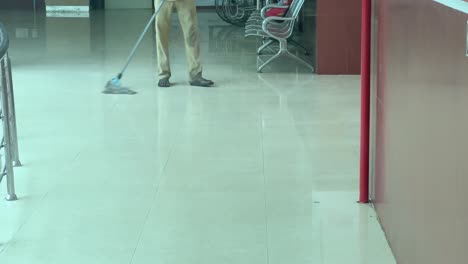 man mopping floor in hospital