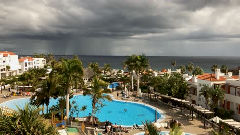 heavy tropical rainstorm over the atlantic ocean time lapse of resort with swimming pool