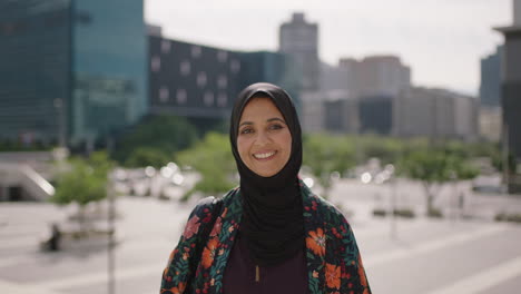 portrait-of-beautiful-mature-muslim-woman-smiling-friendly-at-camera-in-sunny-urban-city-wearing-traditional-headscarf