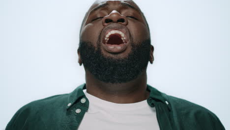 Portrait-of-sick-african-american-handsome-sneezing-on-light-background.